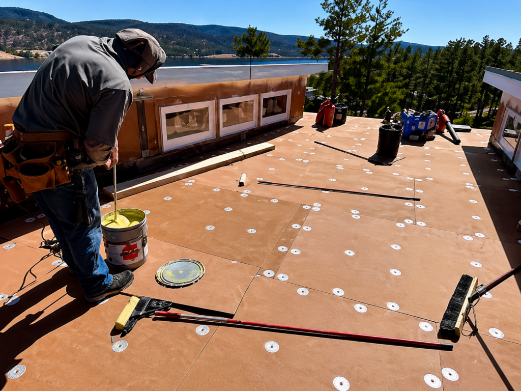 Roof leak repair process on a flat roof in Brooklyn showing damage and sealing work