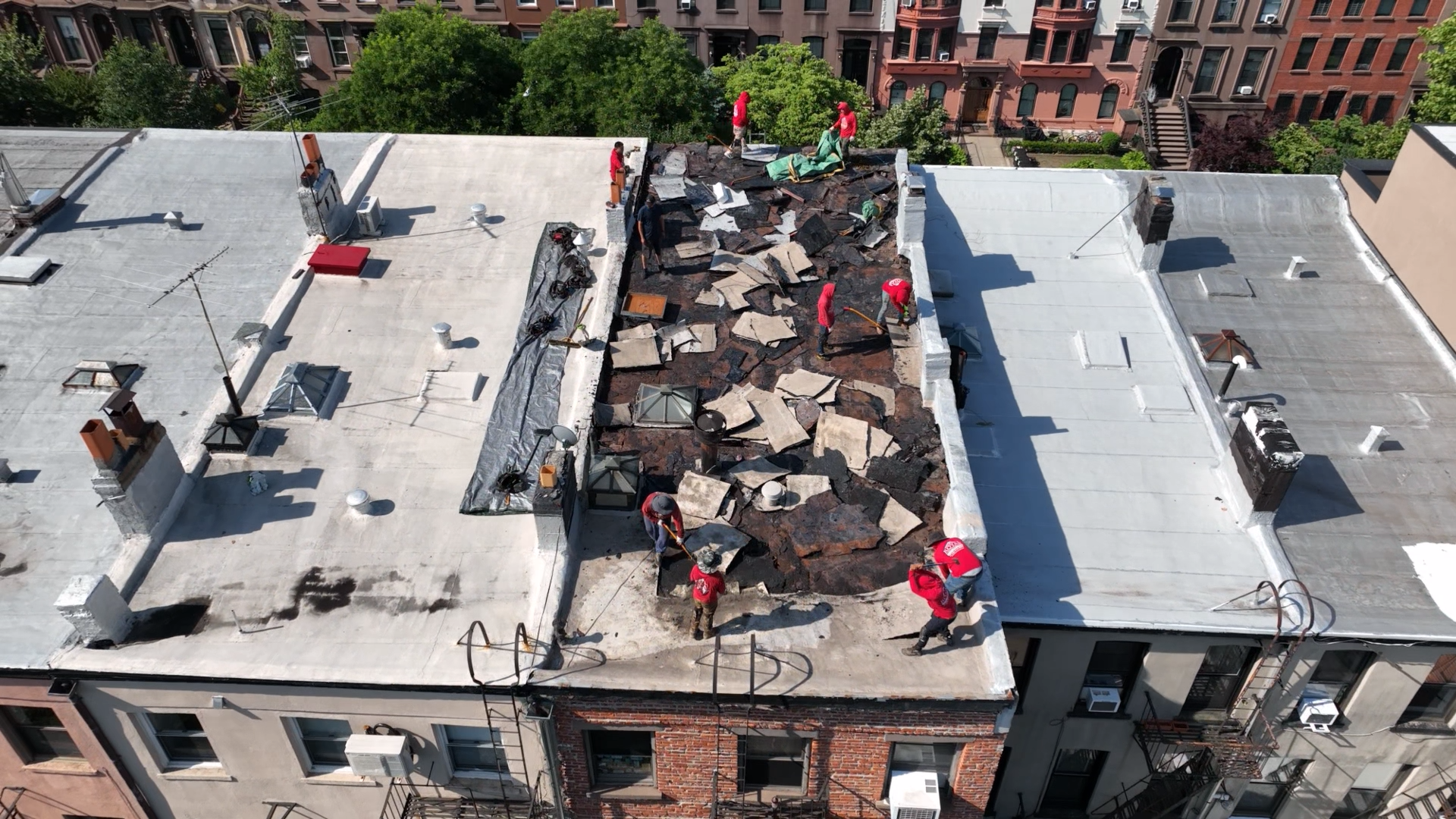 Flat roof lifespan comparison on Brooklyn buildings showing different roofing materials