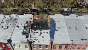 Brooklyn brownstone flat roof with water pooling and leak damage
